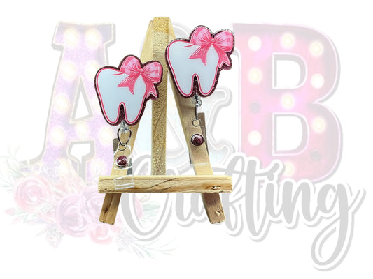 Tooth with small pink bow Badge Reel